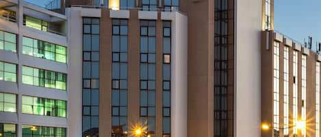 A hotel with a modern facade, multiple windows, and a prominent sign indicating it is a Radisson Blu Hotel.