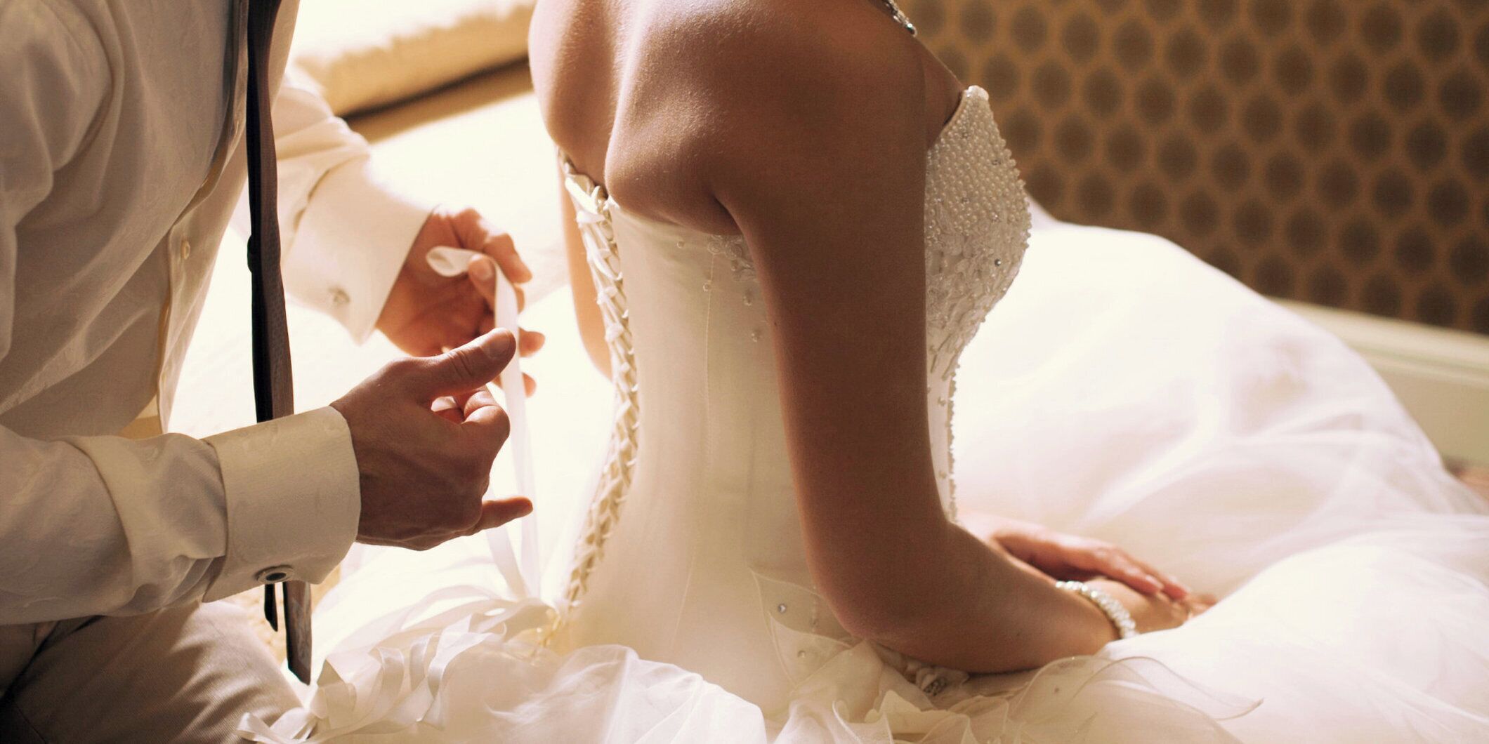 A wedding scene with a bride in a white dress and a groom in a suit.
