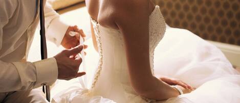 A wedding scene with a bride in a white dress and a groom in a suit.