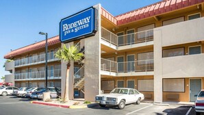 A multi-story hotel with a sign reading "Rodeway Inn & Suites."