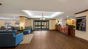 A spacious lobby with a reception desk, seating area, and a view through the glass doors. - Comfort Inn Fayetteville I-95 (Fayetteville)