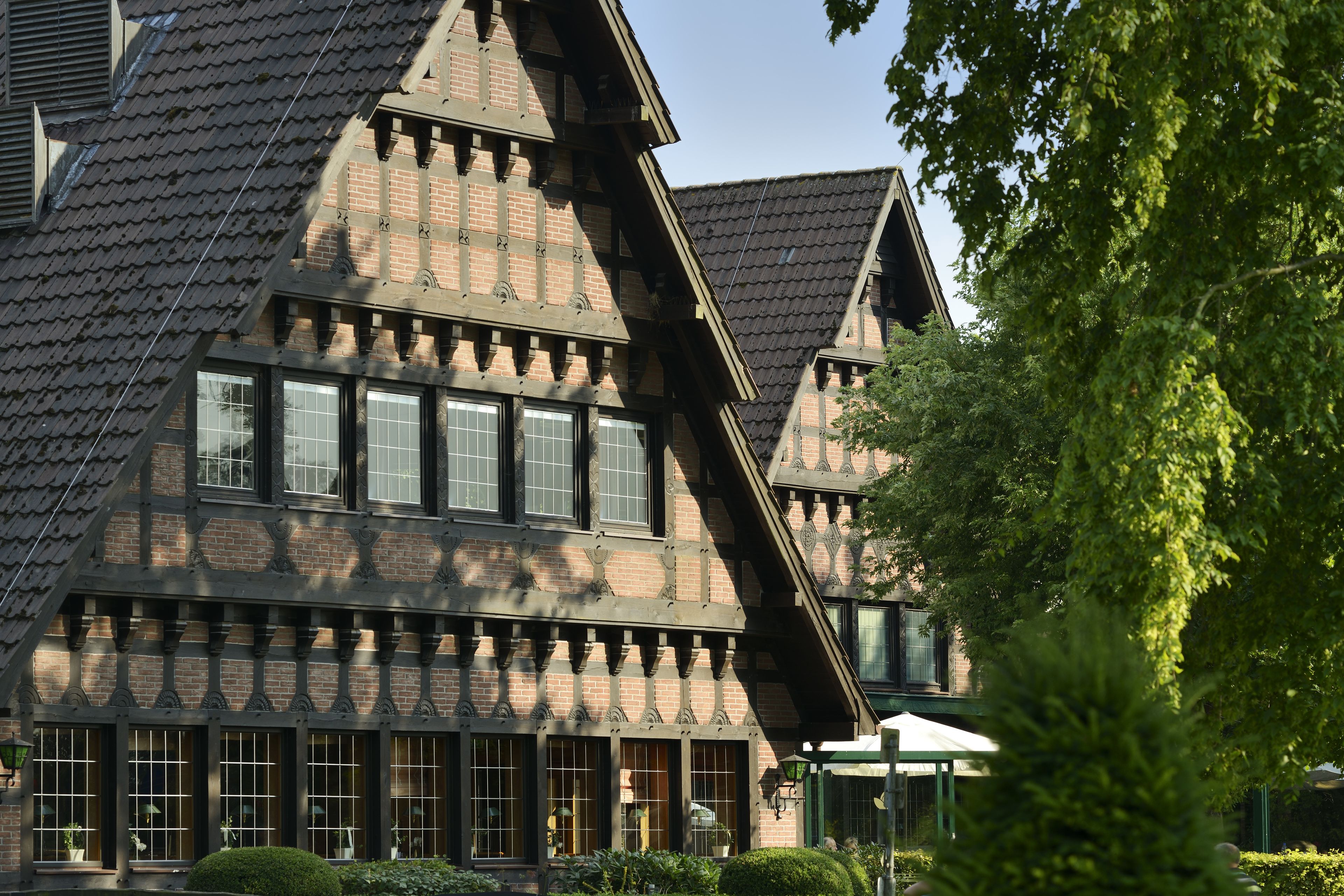 A traditional half-timbered building with multiple windows and a steeply pitched roof.