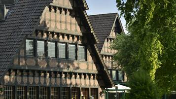 A traditional half-timbered building with multiple windows and a steeply pitched roof.
