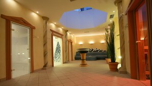A hotel lobby with a skylight, a reception desk, and a staircase.