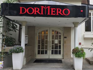 A hotel entrance with a sign reading "DORMERO" above a set of double doors. - DORMERO Hotel Coburg (Coburg)