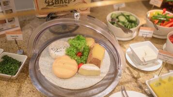 A buffet with various food items including cheese, lettuce, and a sign for 'Baker'.