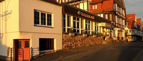 A traditional European building with a sign for 'Ringhotel Roggenland' and 'Roggenland'.