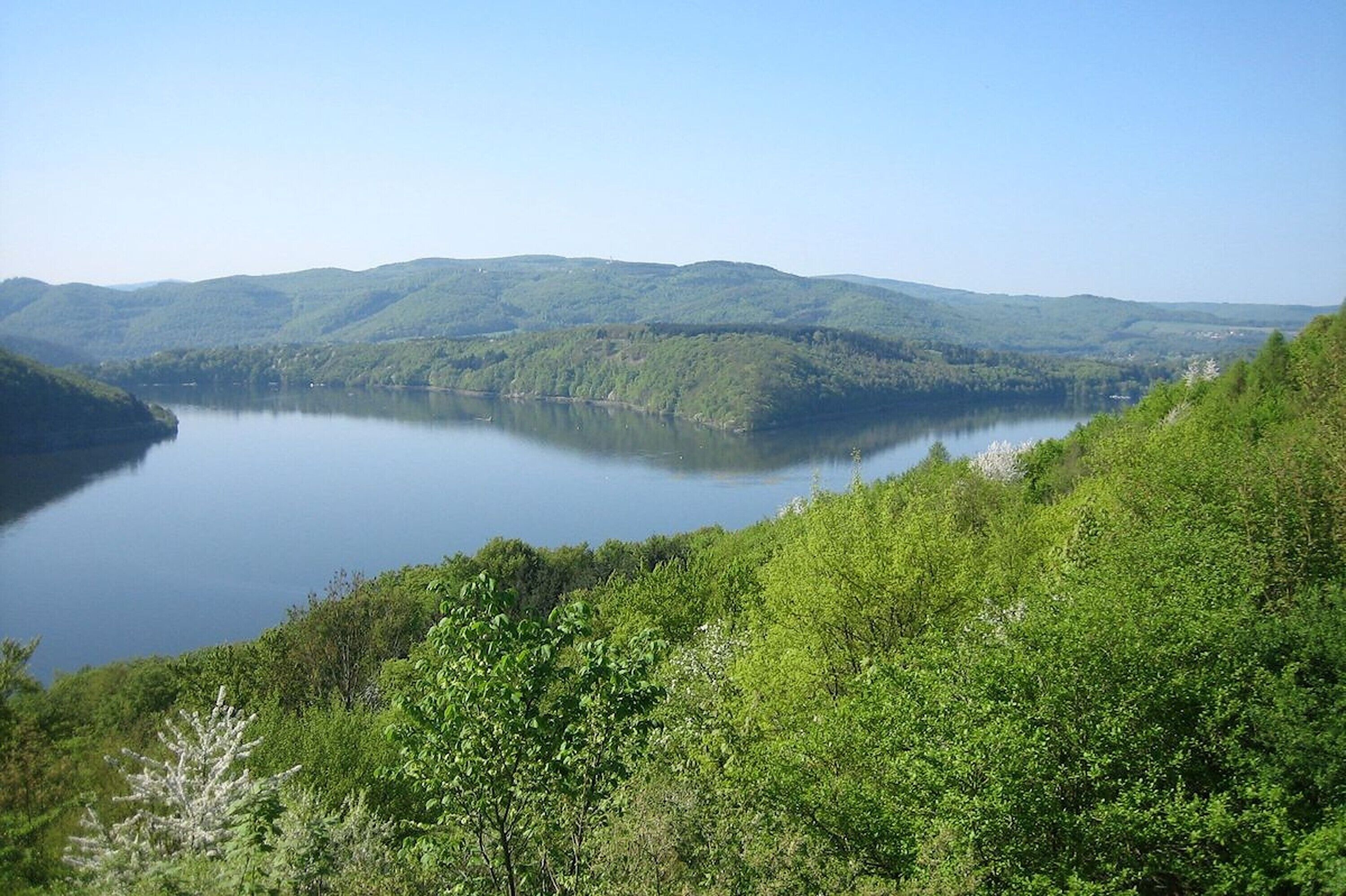A lake surrounded by lush green hills.