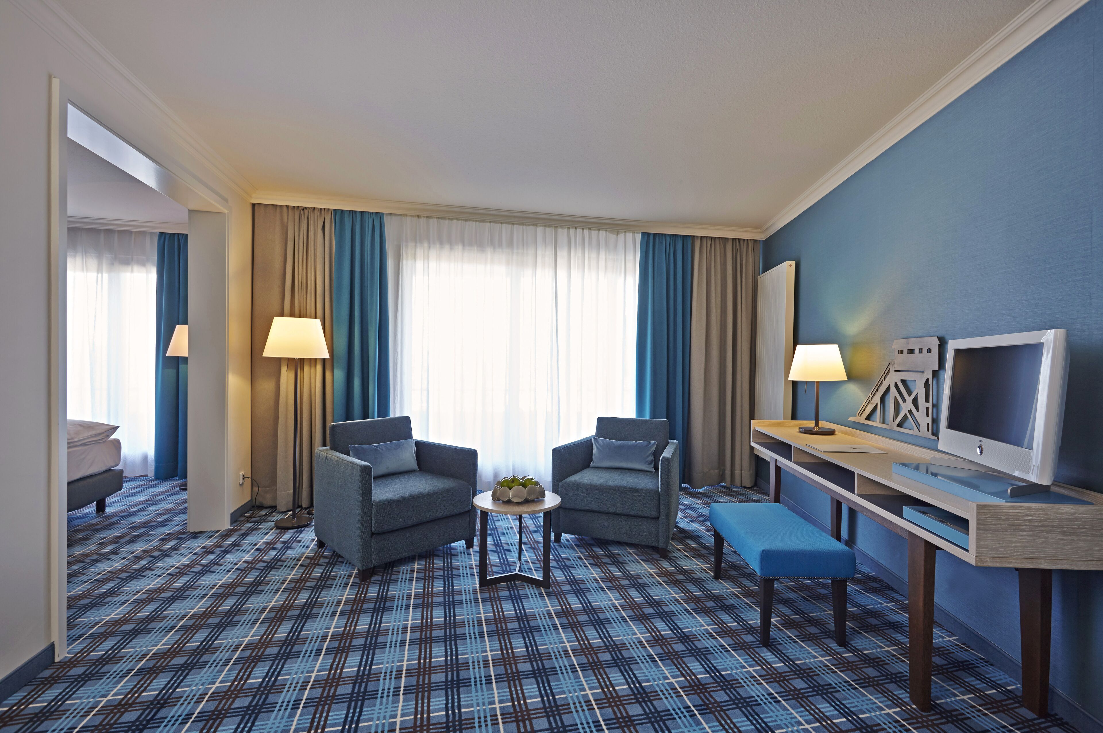 junior suite | living area | 21-inch flat-screen tv with digital channels, tv, heated floors