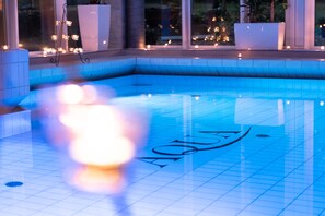 Relax by the AQUA pool, surrounded by a low wall.