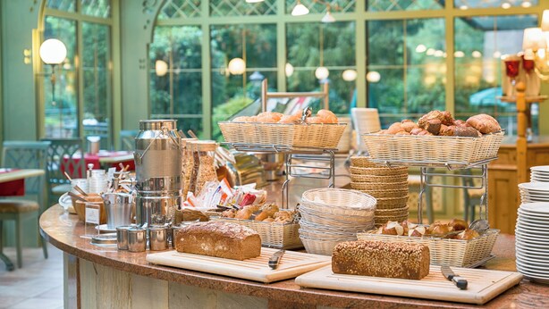 A breakfast buffet with various breads, pastries, and a coffee station. - Ringhotel Mönchs Waldhotel (Unterreichenbach)