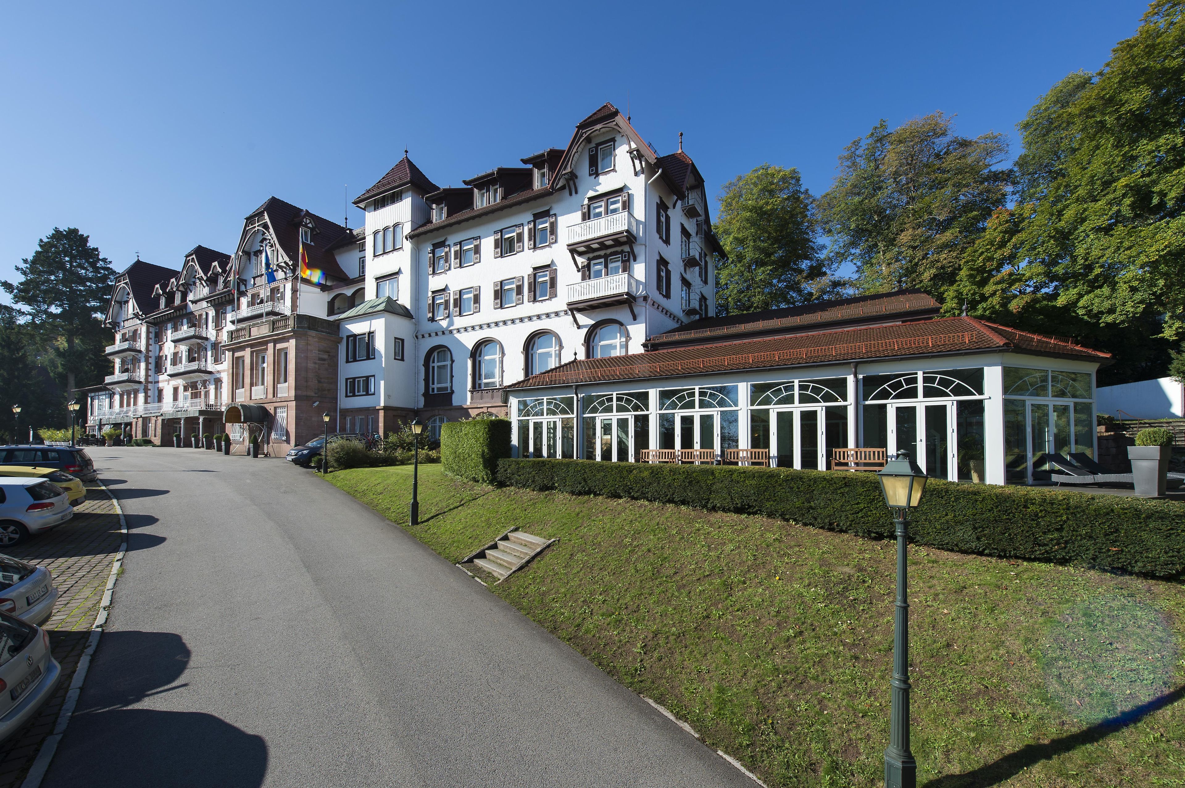 A multi-story building with a traditional architectural style, featuring a series of balconies and a covered walkway.