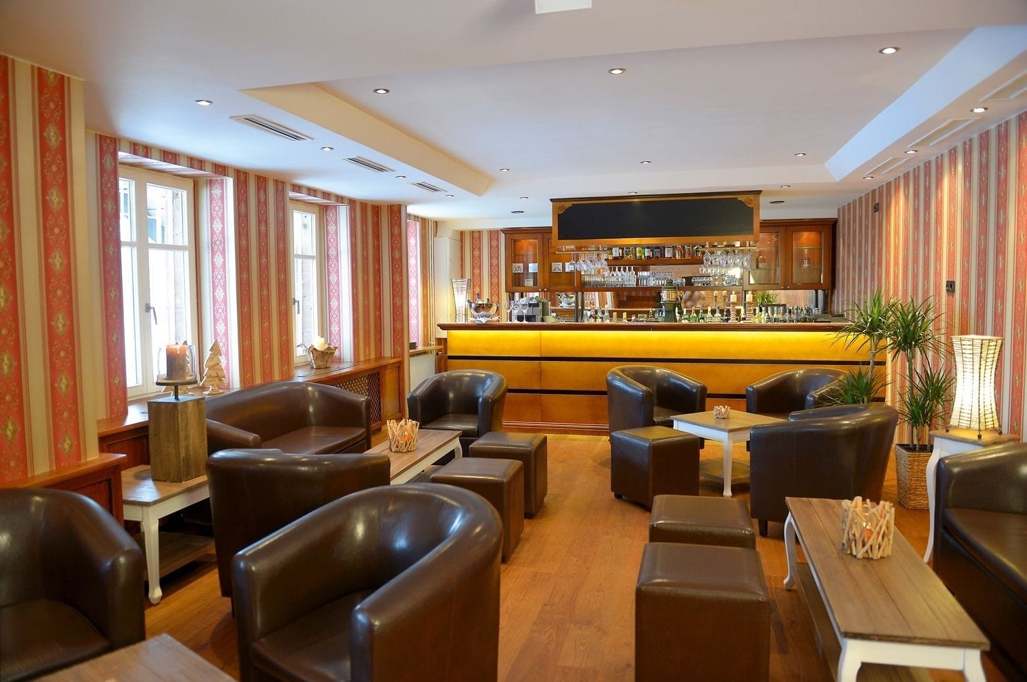 A bar area with leather seating and a bar counter.