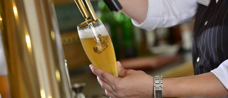 A person pouring beer into a glass.