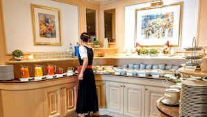 A buffet setup with various food items and beverages.