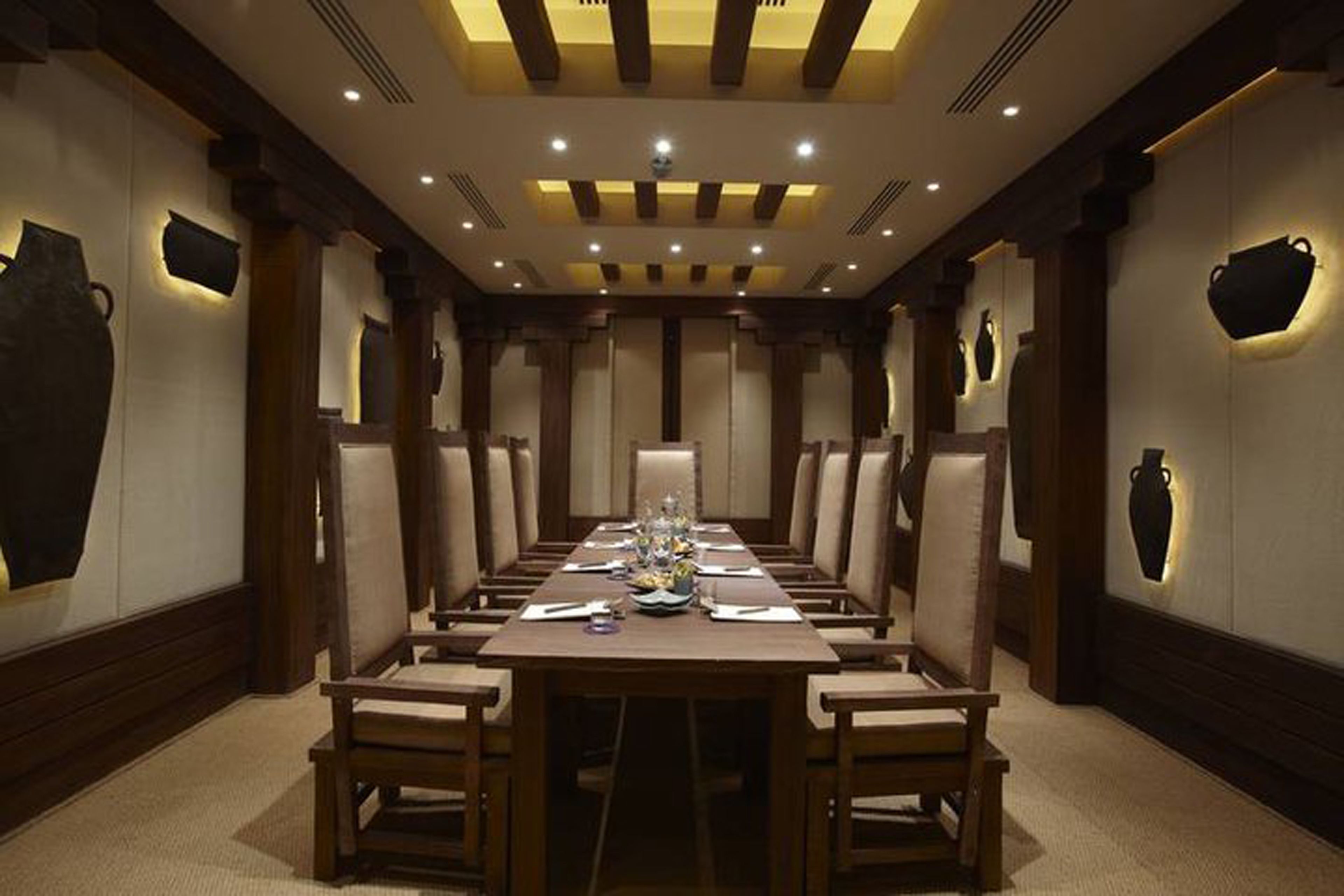 A conference room with a long table, chairs, and a chandelier.