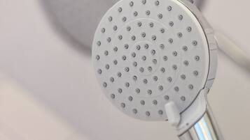 A showerhead with a circular design and multiple holes.