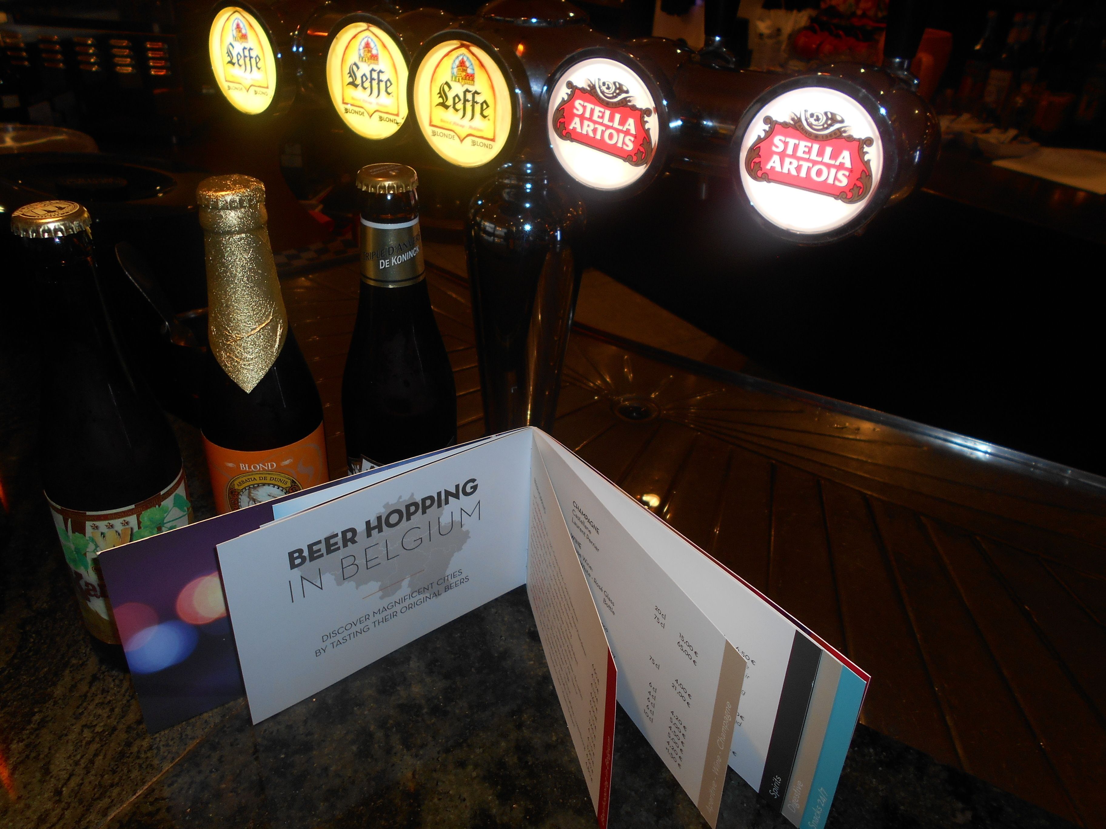 A bar with beer taps labeled 'Leffe Blonde' and 'Stella Artois'.