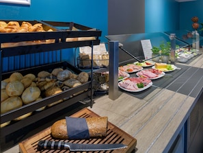A buffet with various breads, pastries, and a selection of meats and cheeses. - ibis Köln Frechen (Frechen)