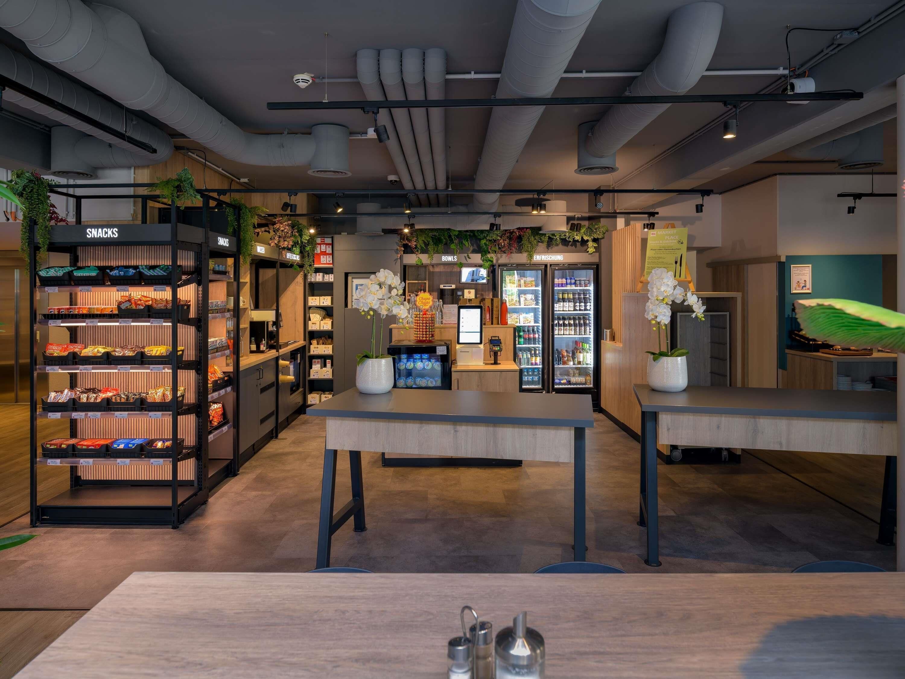 A modern interior with a snack bar, a reception desk, and a seating area.