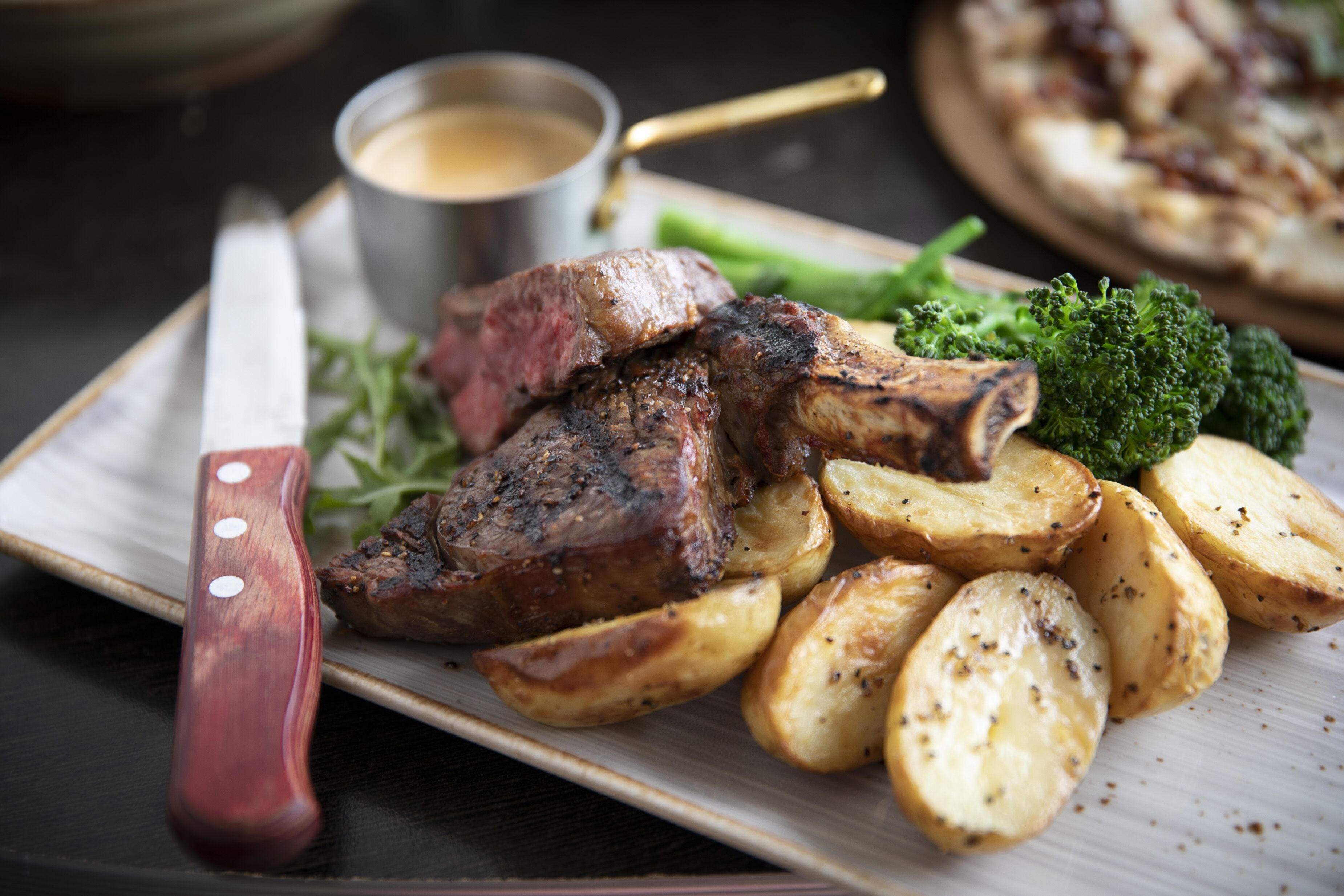 A plate with steak, roasted potatoes, and broccoli.