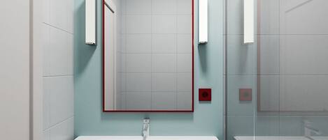 A bathroom with a white sink, a mirror with a red frame, and a towel rack.