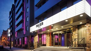 A modern hotel entrance with a prominent sign reading "PULSE8 HOTEL". - Hotel PULSE8 (Prague)