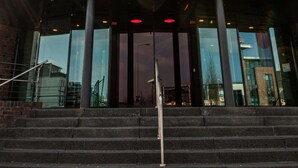 A modern building with a curved glass facade and a sign reading "prizeotel."
