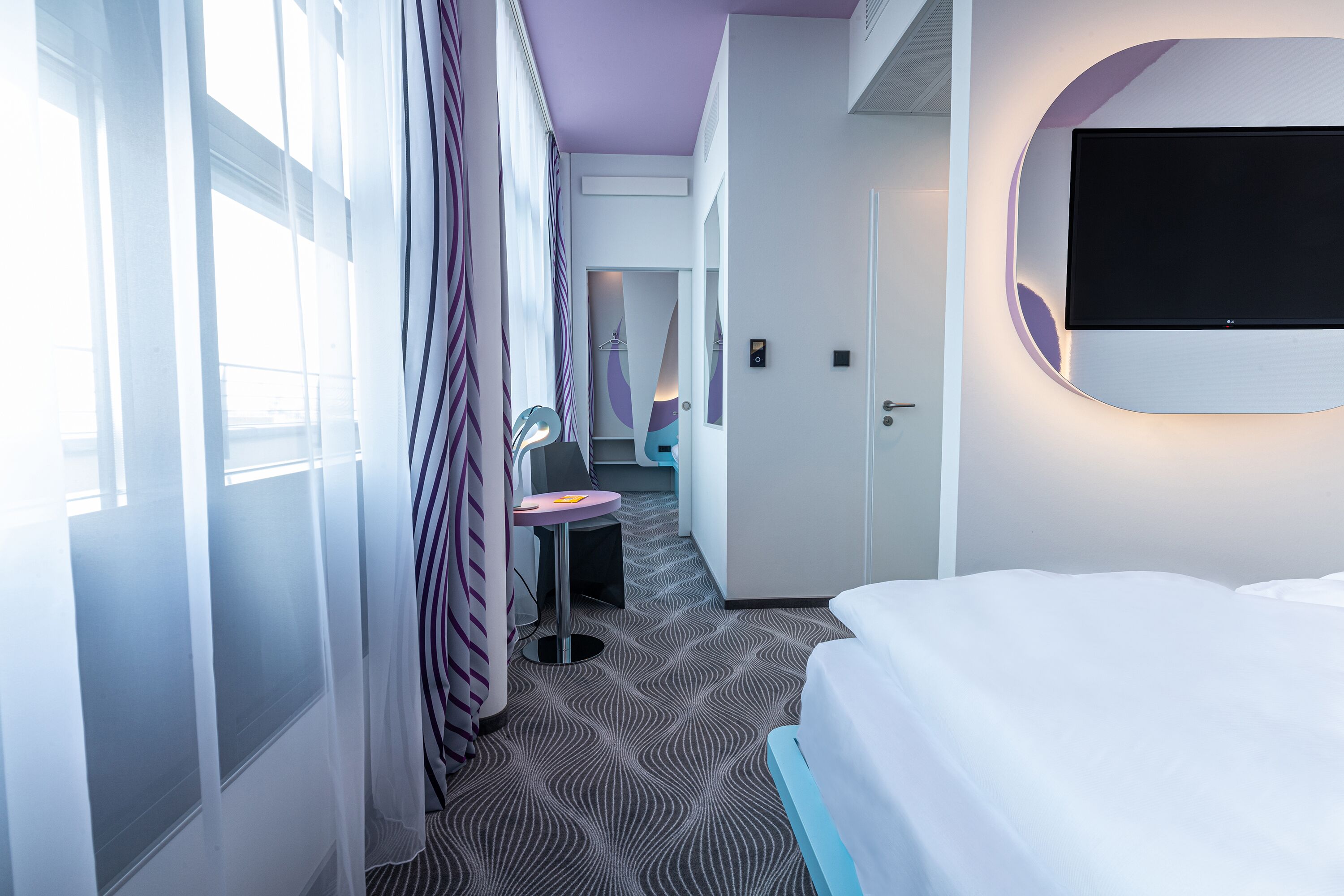 hypo-allergenic bedding, desk, laptop workspace, blackout curtains