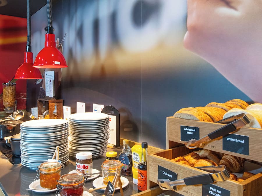 A breakfast buffet with various food items and condiments.