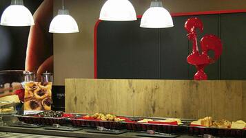 A buffet setup with various food items and a wooden counter.