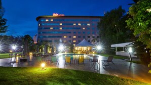 A hotel with a pool area, outdoor seating, and a covered patio. - ibis Antananarivo Ankorondrano (Antananarivo)