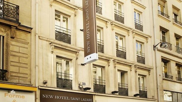 A multi-story building with a prominent sign for the New Hotel Saint Lazare. - New Hôtel Saint Lazare (Paris)