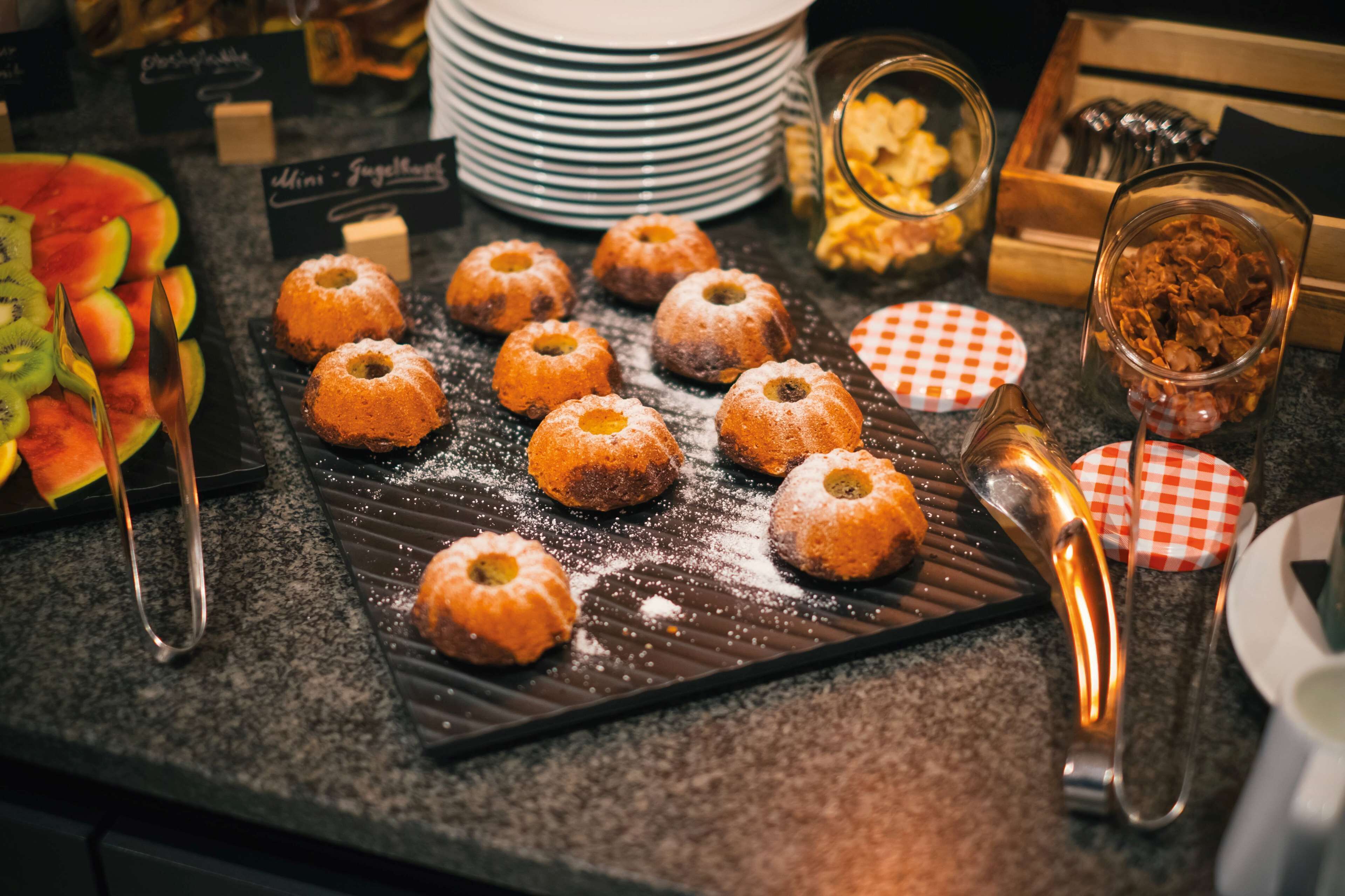 A dessert display with various pastries and fruits.