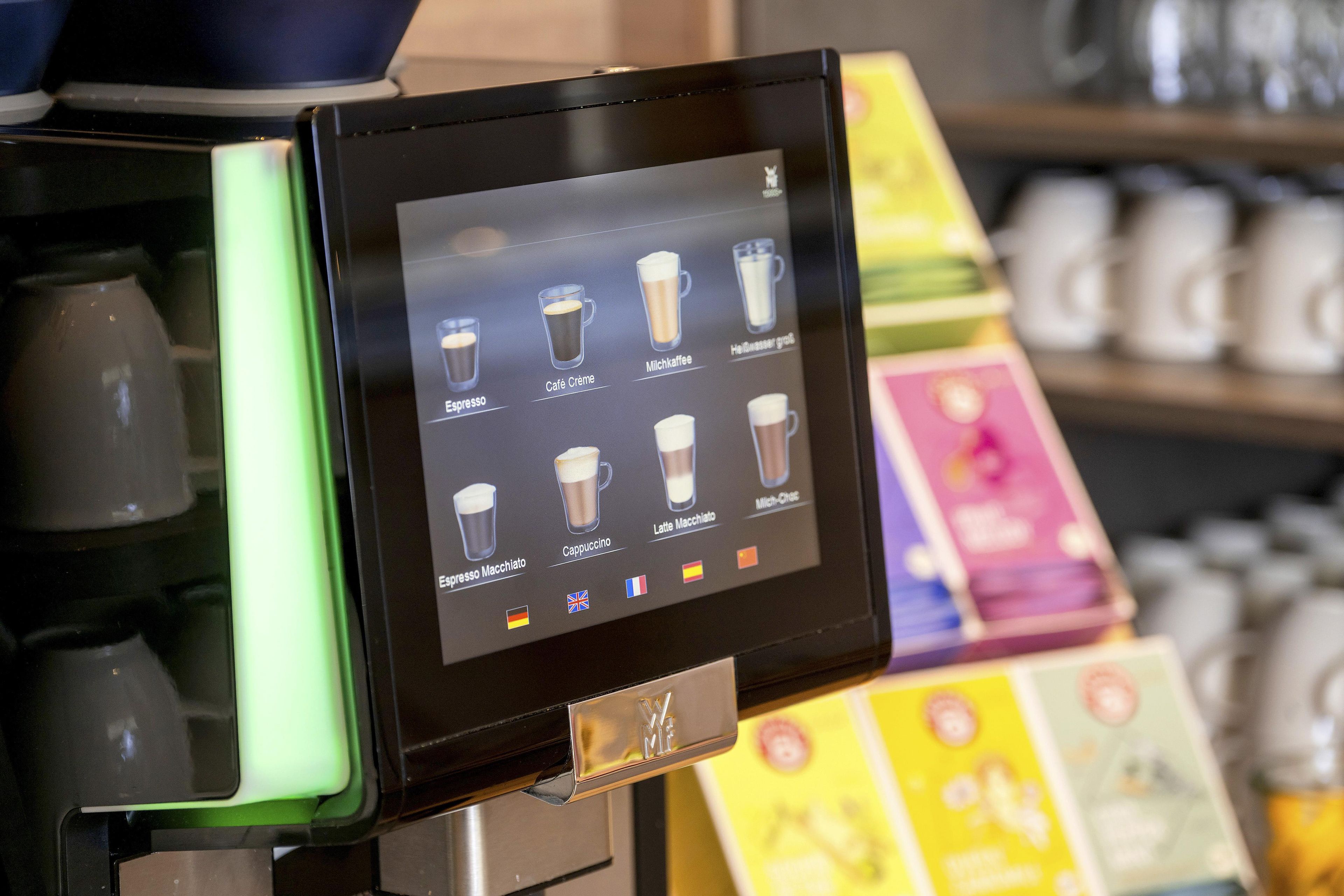 A coffee machine with a digital display menu.