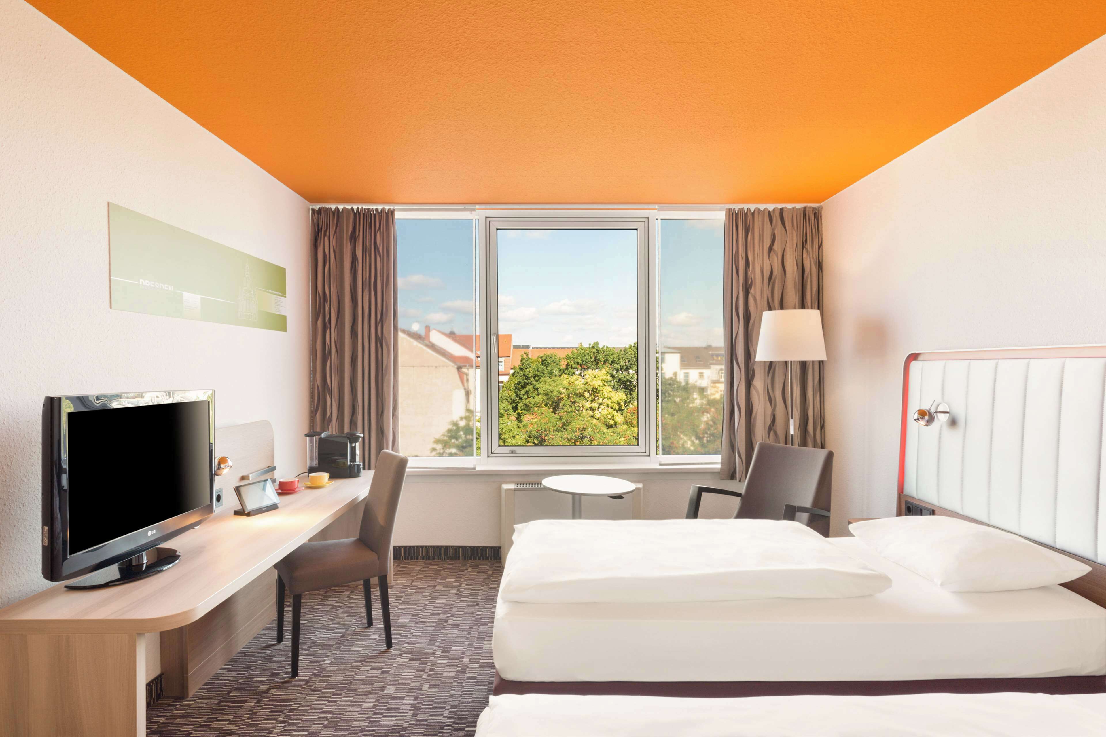 hypo-allergenic bedding, desk, laptop workspace, blackout curtains