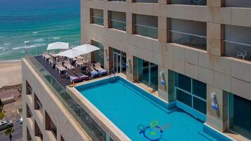Seasonal outdoor pool, open 11:00 AM to 5:00 PM, pool umbrellas