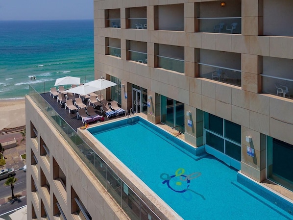 Seasonal outdoor pool, open 11:00 AM to 5:00 PM, pool umbrellas