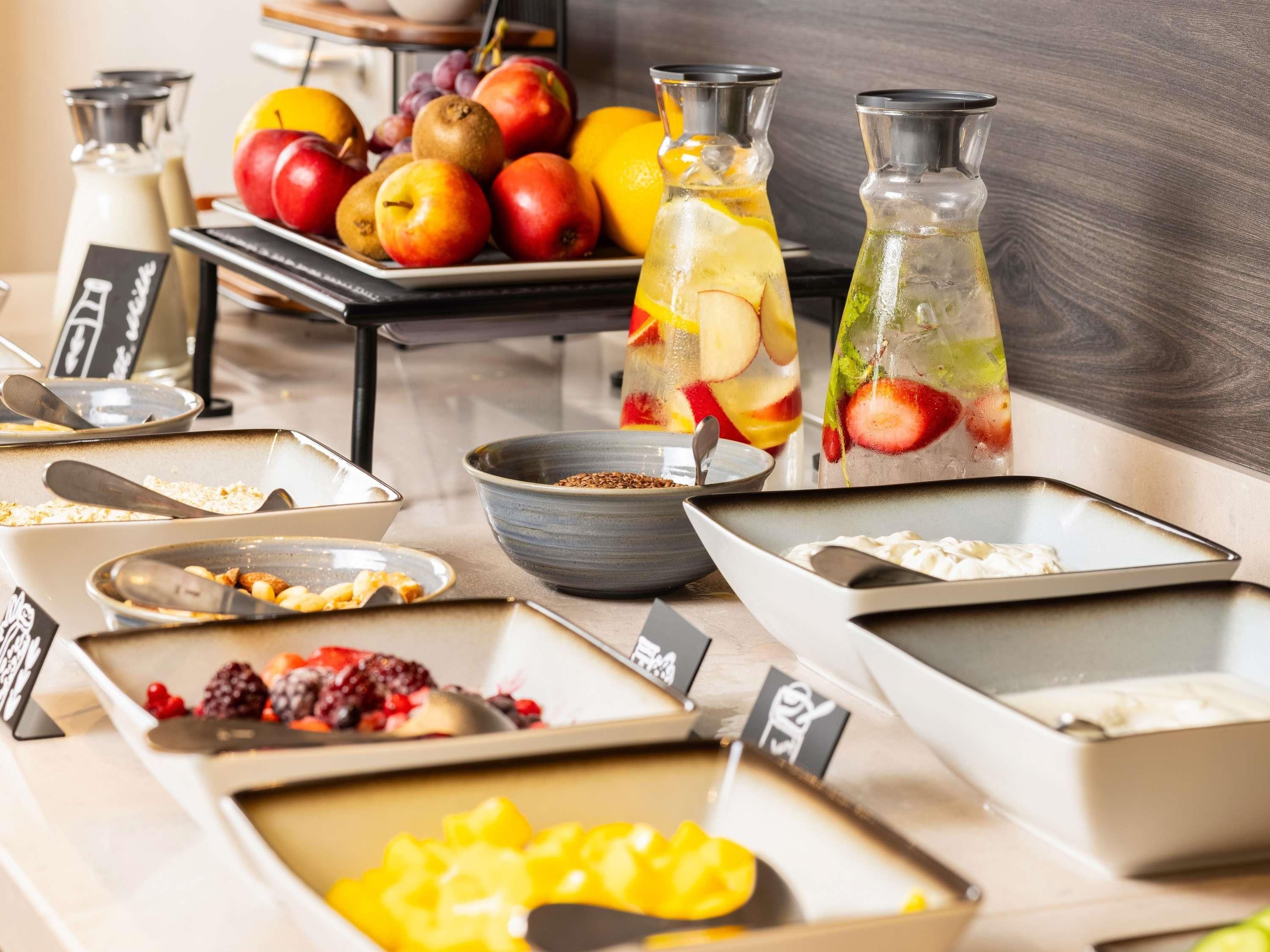 A breakfast buffet with various food items and beverages.