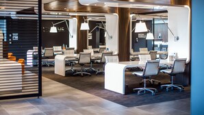 A modern reception area with a counter, seating, and pendant lighting. - Postillion Hotel Dordrecht (Dordrecht)