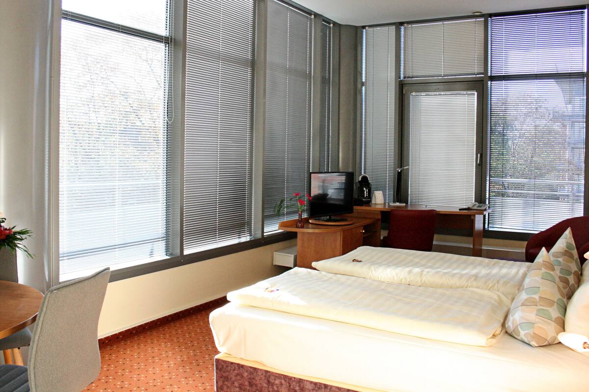 comfort room | in-room safe, desk, blackout curtains, iron/ironing board