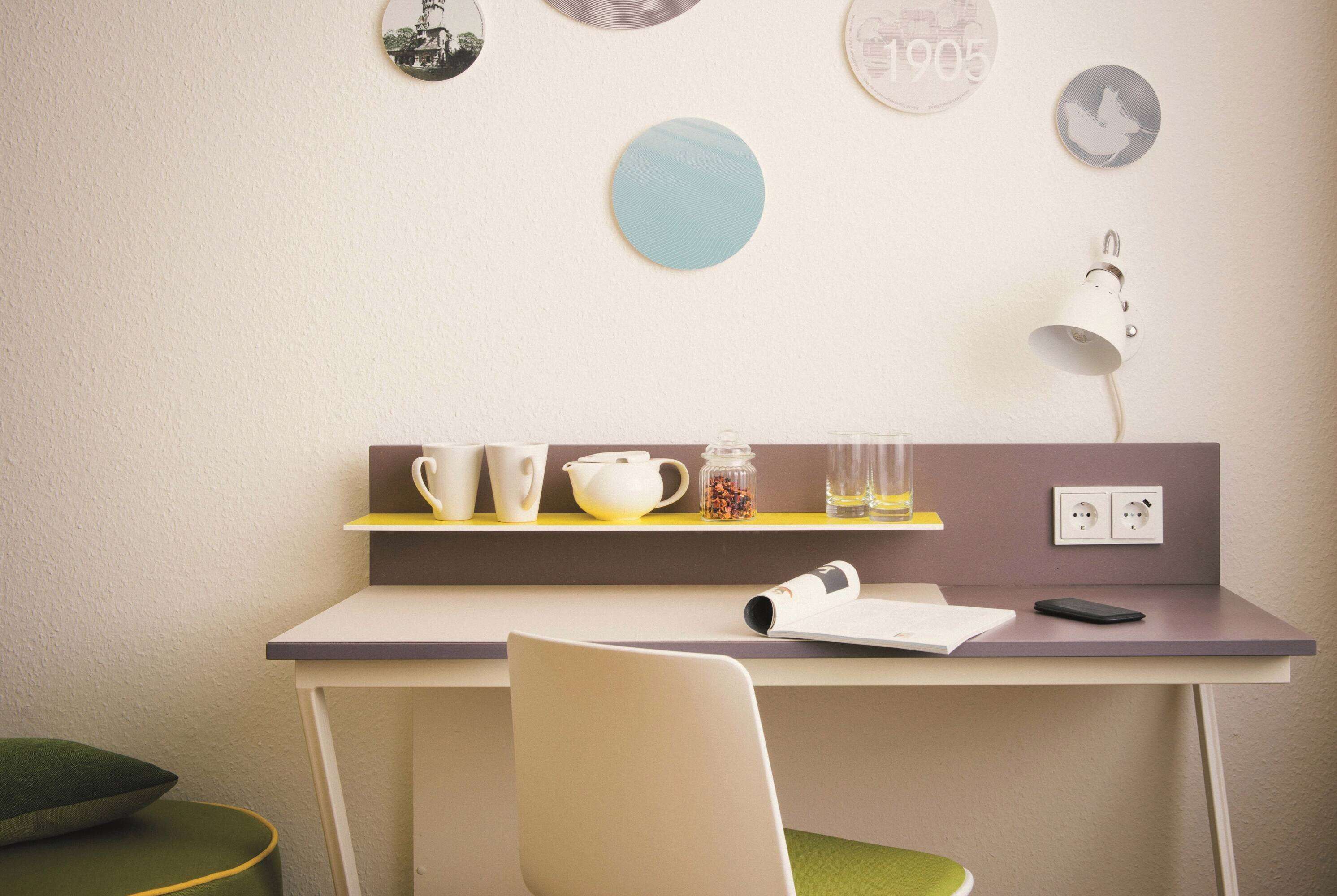 A modern workspace with a desk, chair, and various office supplies.