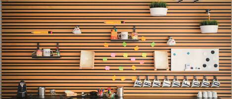 A modern kitchen with wooden slats, a coffee machine, and various kitchen utensils.