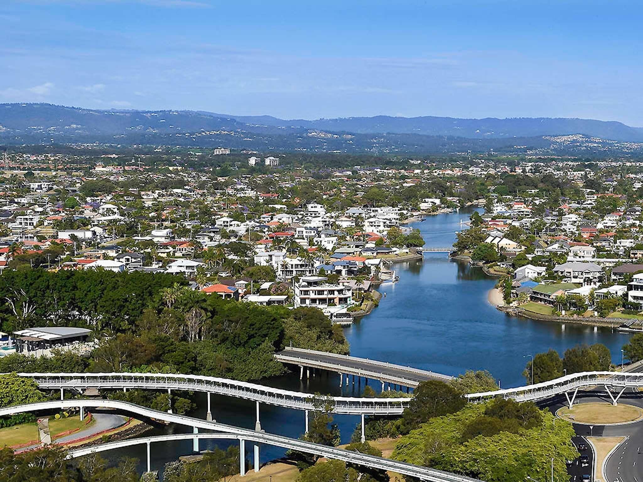 A river running through a town with bridges and residential buildings.