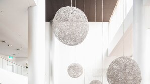 A spacious lobby with high ceilings, large spherical chandeliers, and a reception desk. - Sofitel Gold Coast Broadbeach (Broadbeach)