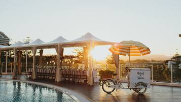Guests can dine al fresco in a tranquil setting adjacent to the pool.