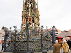 A historic tower with intricate architectural details and a decorative fence in front. - Congress Hotel Mercure Nürnberg an der Messe (Nuremberg)