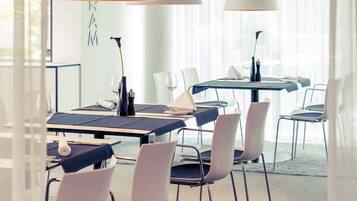 A modern conference room with tables, chairs, and lamps.