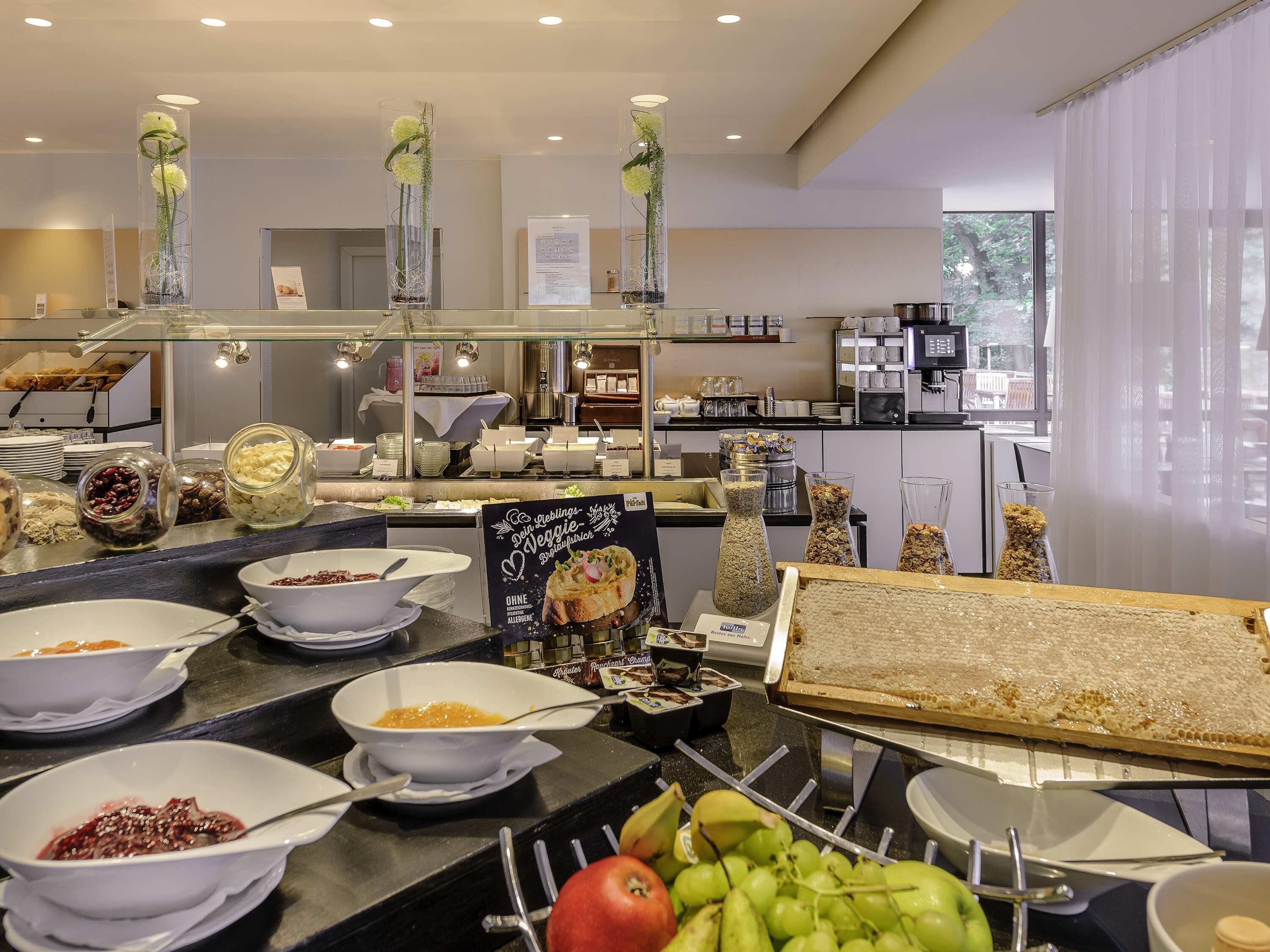 A buffet area with various food items and a sign indicating 'Veggie Delight'.