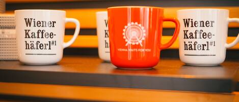 Three coffee mugs with text on them.